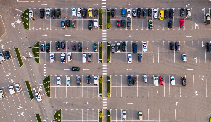 Aerial view of a parking lot showing several rows of cars neatly parked in designated spaces
