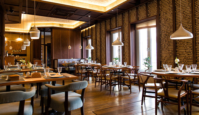 Modern restaurant interior with tables, chairs and ambient lighting