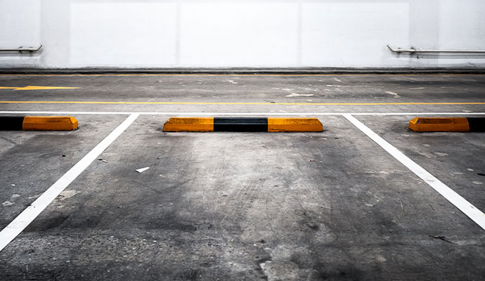 Indoor parking space with dirt, debris and stains on the floor