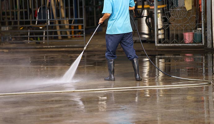 Expert cleaning parking area with water pressure