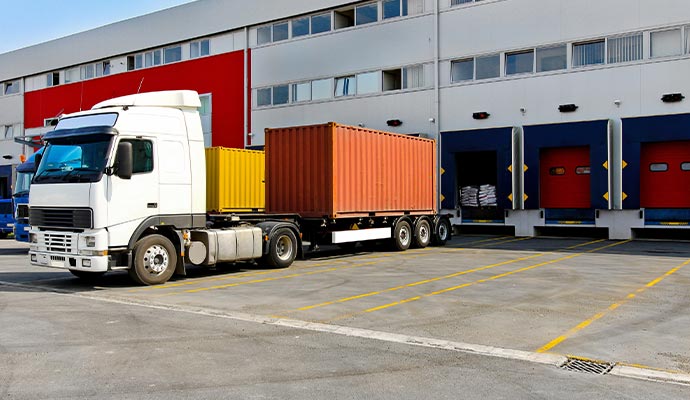 A semi-truck at a commercial warehouse loading dock