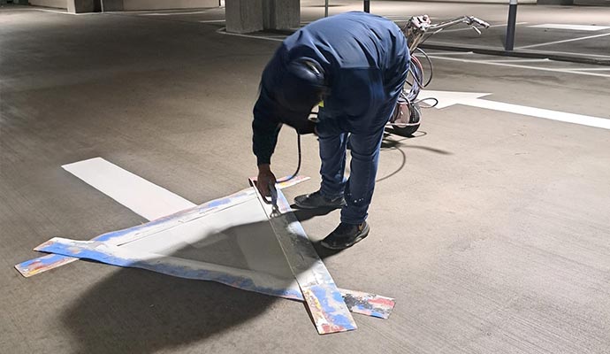 A professional making directional arrow on road