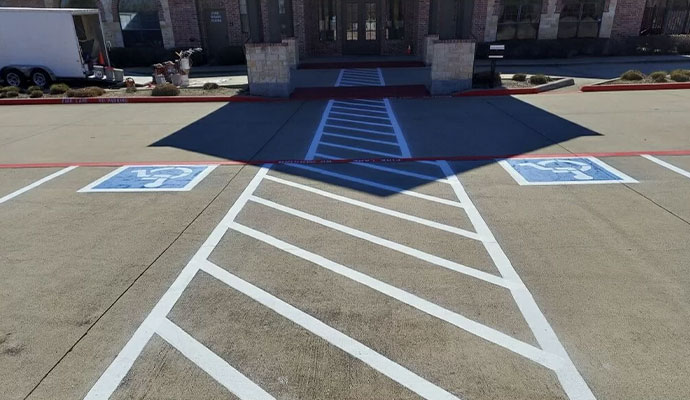 Striped parking lot with designated handicap accessible parking spaces