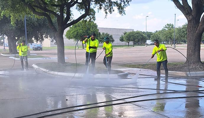 Team of professionals cleaning a parking lot