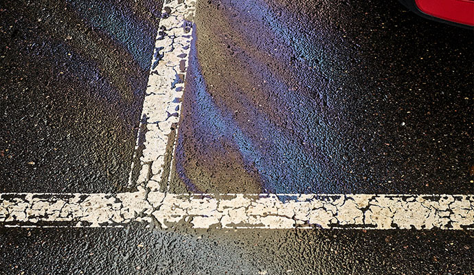 Parking lot surface stained with oil and grease