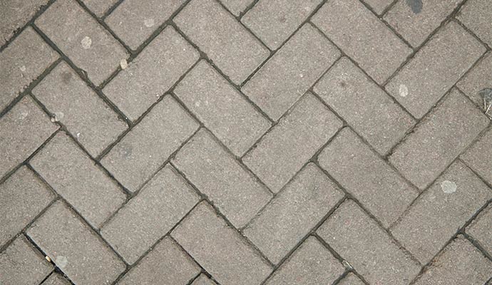 Gray brick road with visible white chewing gum spots