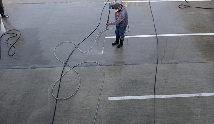 A person is cleaning parking lot A person is cleaning parking lot