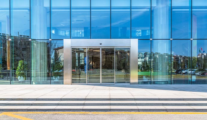 Entrance to a modern commercial glass building.