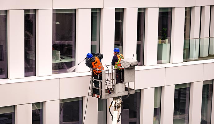 Person cleaning windows with equipment