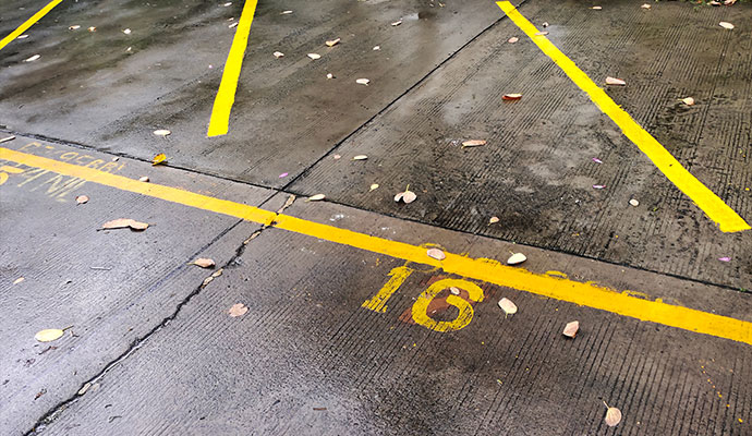 Parking space with a slippery surface due to water or oil