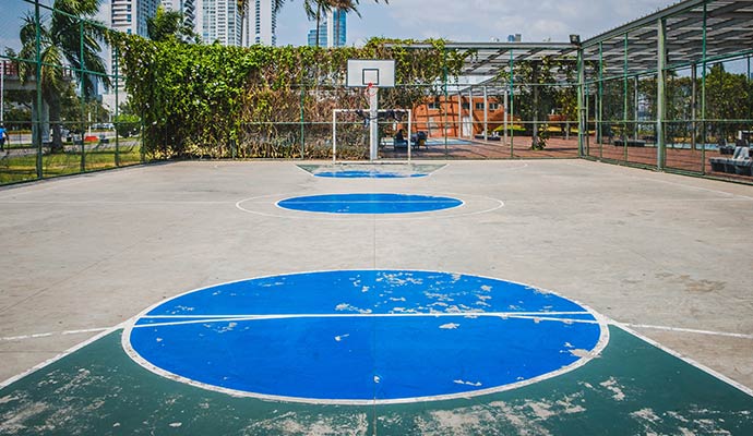 Worn and peeling paint on outdoor basketball court